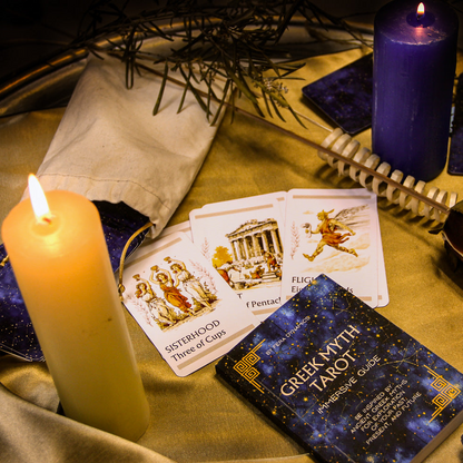 Tarot cards, candles, and a book on a table with a mystical atmosphere.